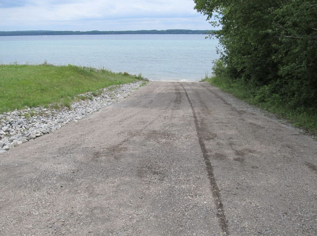Gravel ramp with riprap edging — looking out at Torch Lake from the launch